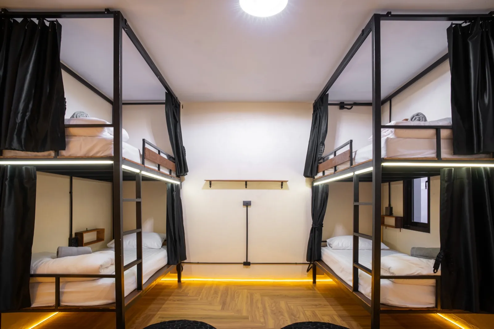 Pod-style dorm bunks with privacy curtains at The Hub Laidback Hostel in Ao Nang