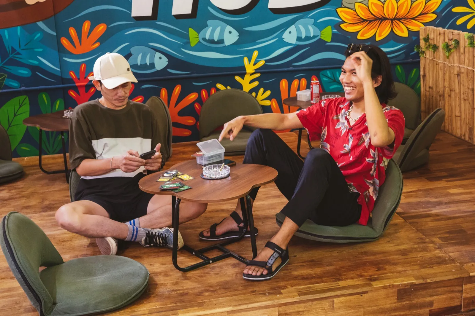 Backpackers hanging out in the social cannabis lounge at The Hub Laidback Hostel, Krabi