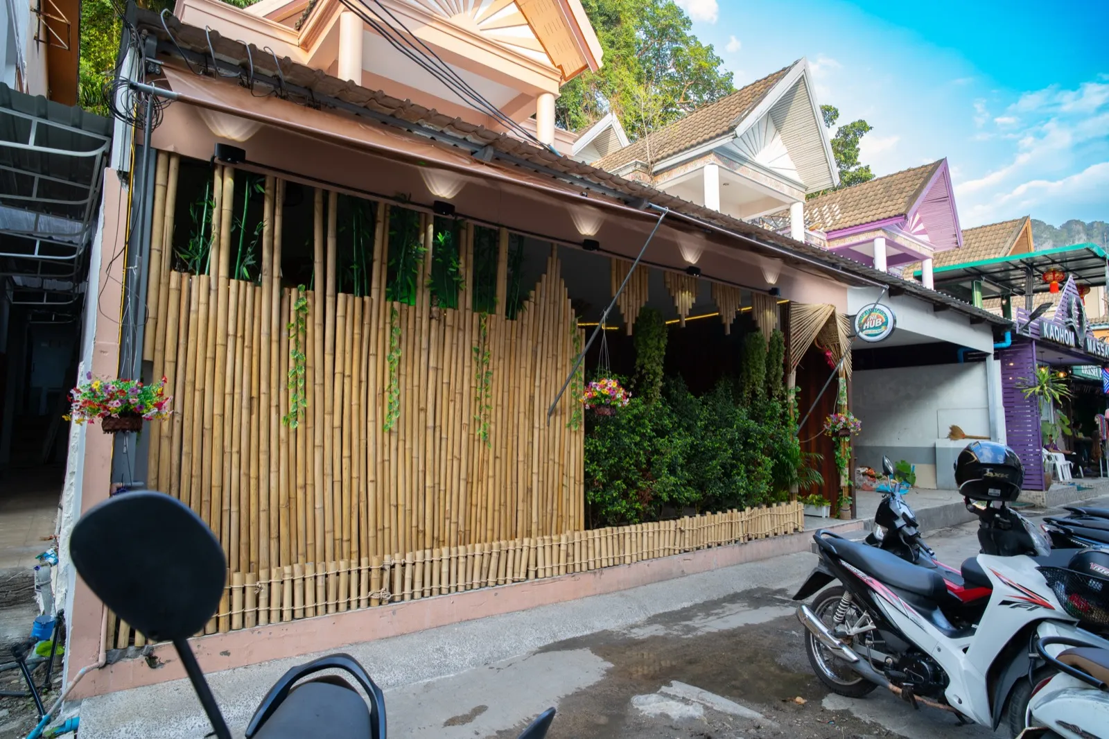 The Hub's green cannabis-leaf neon sign at the weed shop entrance in Ao Nang Beach, Krabi